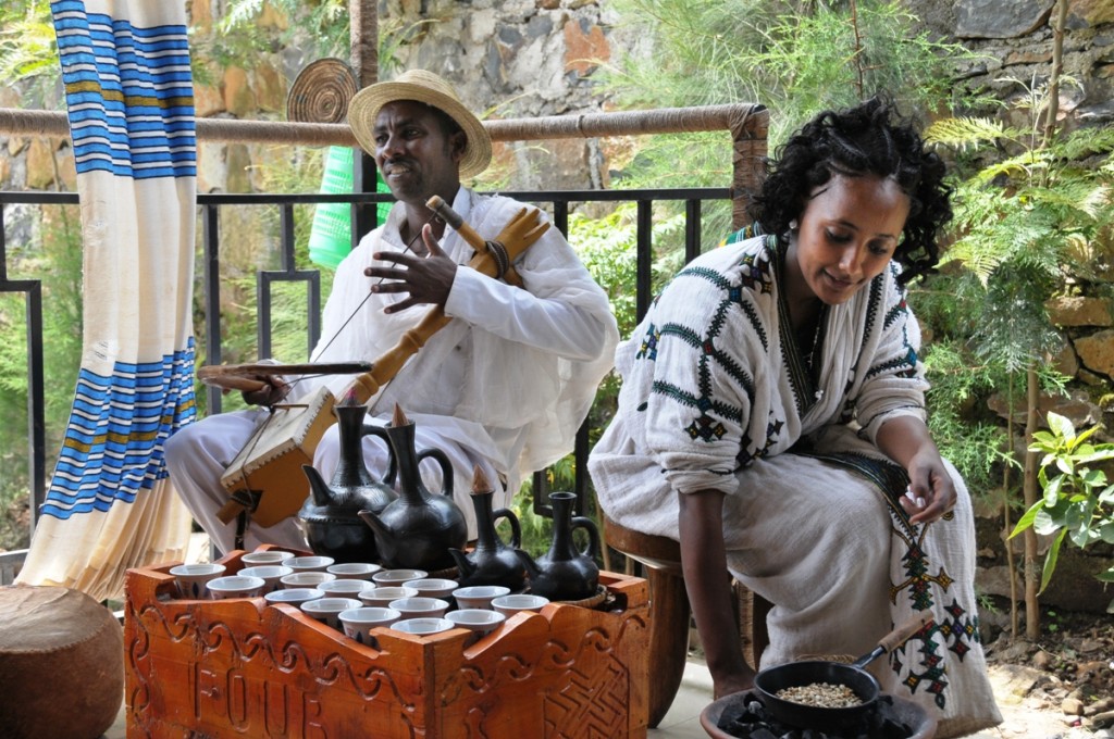 An azmari plays the masenqo during a coffee ceremony